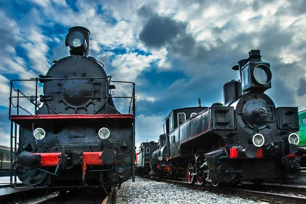 Retro locomotives. Two black locomotives. Locomotives on the railway tracks. An old railway.