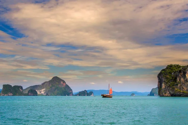 Thailand. The island of Phuket. A lonely sailboat. Sea excursions in Thailand. Walk on the sea near the island of Phuket.