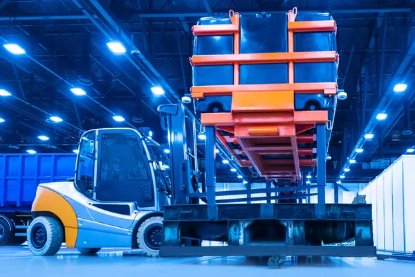 Heavy forklift carries container. Warehouse loader for transport
