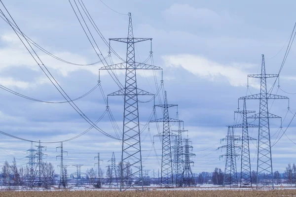 Electric towers with wires. Electric high voltage tower with electric line against clear blue sky.