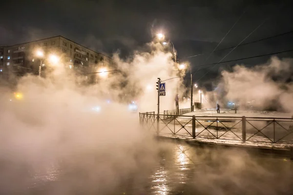 Breakthrough of the water supply system. Hot water flooded the streets. Steam from breaking the pipe with hot water. Natural disasters. Technological disaster. — Stock Image Breakthrough of the water supply system. Hot water flooded the streets. Steam from breaking the pipe with hot water. Natural disasters. Technological disaster. Stock Photo