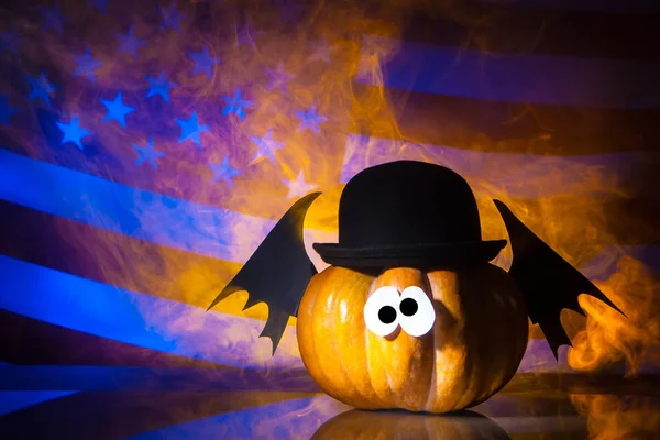 Pumpkin on American flag background. Halloween on a background of a flag of the USA