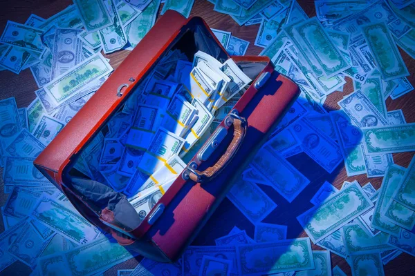 Money in the case. A lot of dollars. Dollars in an old suitcase.