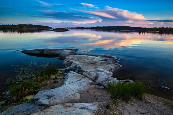 Sunset in the reflection of water. Wild nature of the north. White Nights. Karelia. Ladoga lake. Russia. — Stock Image Sunset Reflection Water Wild Nature North White Nights Karelia Ladoga Stock Photo