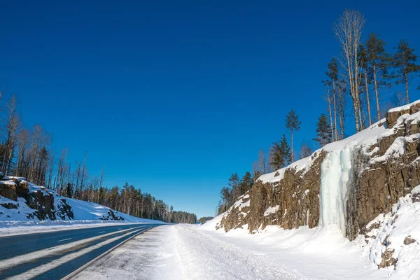 Karelia. Russia. Frozen waterfall along the road. Karelian water