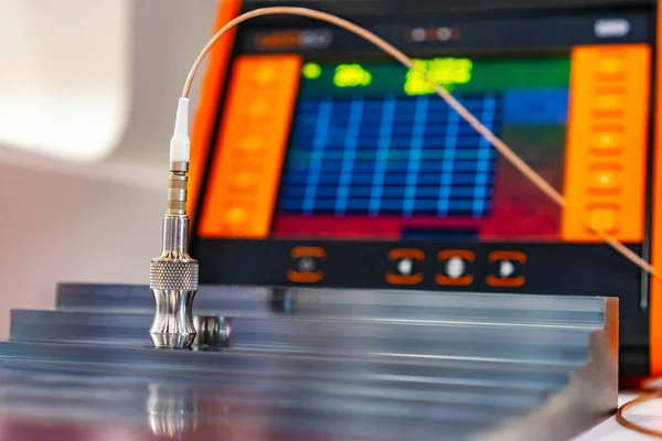Ultrasonic metal inspection. Oscilloscope with color touchscreen