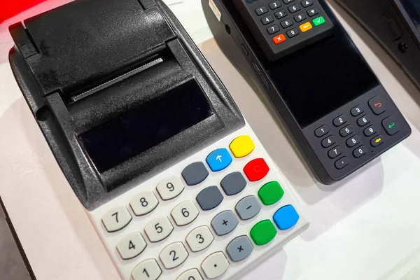 Cash registers on the table. Cash desk for payment by card. Mobile cash register. Portable online cash desk. Trading acquiring. POS-terminal for bank cards in the store. Devices for cashless payments.