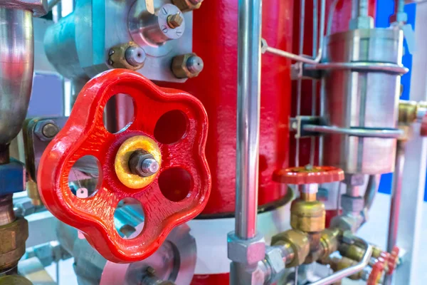 Red valve close-up. Fragment of an automated fire extinguishing system. Extinguishing fires in the enterprise. Human security. Robotic fire system. The control of fire. Firefighting.