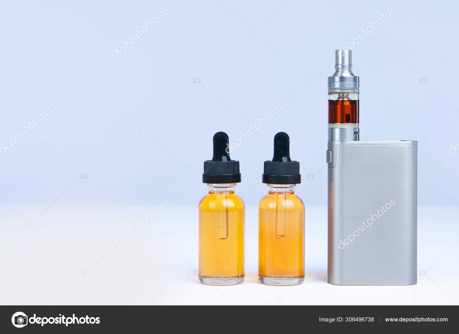 hjælpe Kriger Citron Electronic cigarette and two bottles of liquid for it. The vaping concept.  Smoking VAPE. Electronic cigarette Smoking accessories. Vaping gadgets.  Stock Photo by ©GrinPhoto 306496738