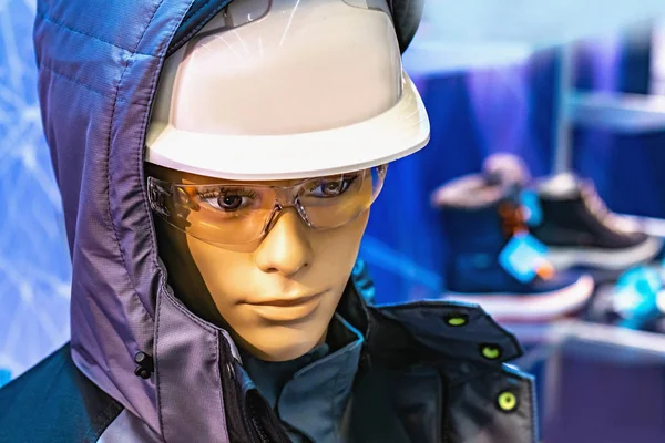 Overalls on a mannequin. Safety glasses on a mannequin. Mannequin in a helmet. Welding glasses. Sale of special clothing. A uniform. Workwear shop. Dummy in a protective helmet. Winter uniform.