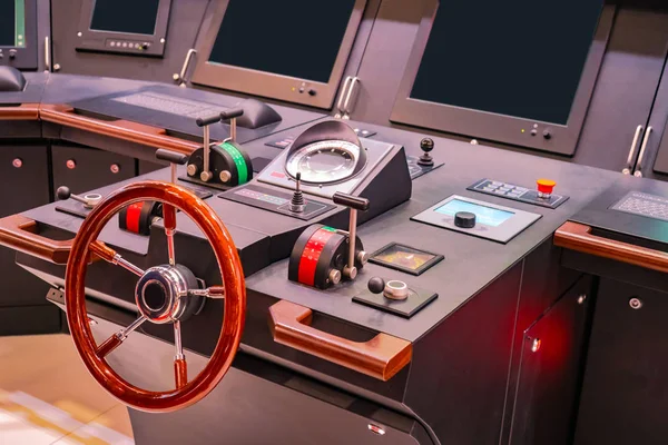 Captains bridge. Boat control panel with steering wheel on the captain bridge. Wheelhouse on a motor yacht. The place of the captain of the ship. Electronics on a modern ship. Boat management courses.