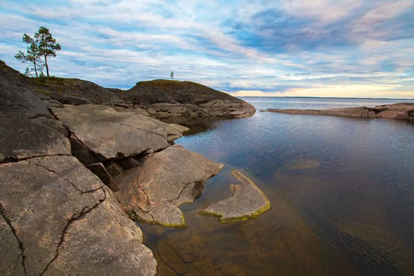 Karelia. lake Ladoga. nature of Russia. Rocky coast of the island. Lake with rocky bottom. Panorama of wildlife. Two pines on a rocky island. Sparse vegetation. Travelling to Karelia. — Stock Image Karelia. lake Ladoga. nature of Russia. Rocky coast of the island. Lake with rocky bottom. Panorama of wildlife. Two pines on a rocky island. Sparse vegetation. Travelling to Karelia. Stock Photo