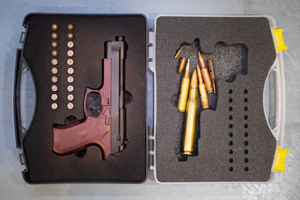 Cartridges. Pistol. The gun next to the cartridges. Weapons Suitcase for the pistol. Buying weapons. Cartridges of different calibers next to the pistol. Case for weapons. Gun storage. Collection gun