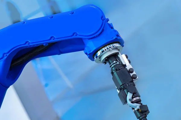 Robotics. Blue Hand of the manipulator. Modern technologies. Modern production. Production using robotics. Robotic factory. Industrial Robot Manipulator. Robot Gripper. Heavy industry.