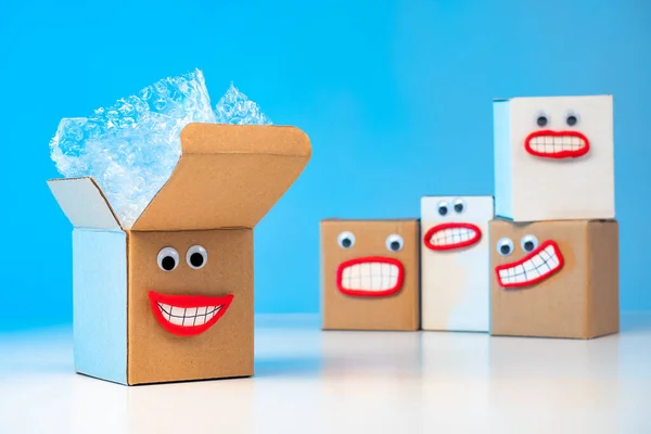 Emoji. Good emotions when receiving packages. The joy of unpacking. Happy boxes. Positive emotions from shopping. The boxes are waiting to be unpacked. Facial expressions containing boxes. Joyfulness