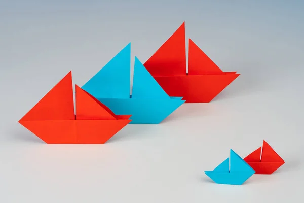 Paper boats. Concept - business size. Medium and small business. Ships made of paper of different sizes. Small versus large. Commonwealth based on sizes. Small companies versus corporations.