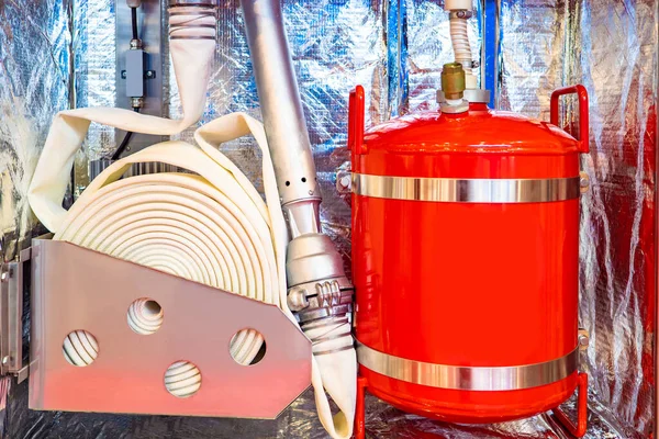 Firefighting. Modern fire extinguishing system. Fire fighting equipment. Industrial fire protection. Flame extinguishing system in the industry. Red tank, valve and hose.