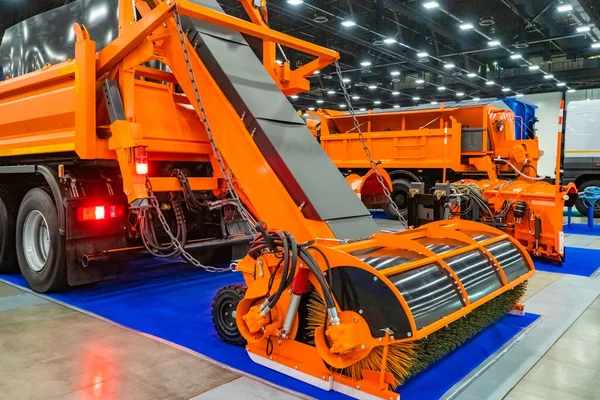 Demonstration of equipment for street cleaning. Harvesting machines are orange. Equipment for cleaning dust, dirt and snow. Multifunctional transport for cleaning the city.