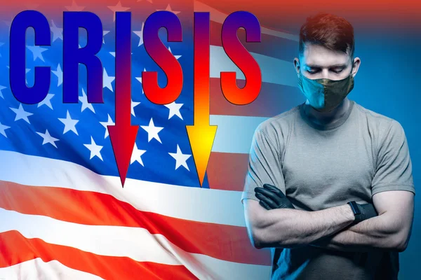 Crisis in the USA. Man in a protective mask as a symbol of a pandemic. Concept - signs of approaching crisis. Beginning of recession due to fever. Inscription crisis on background of  flag of America