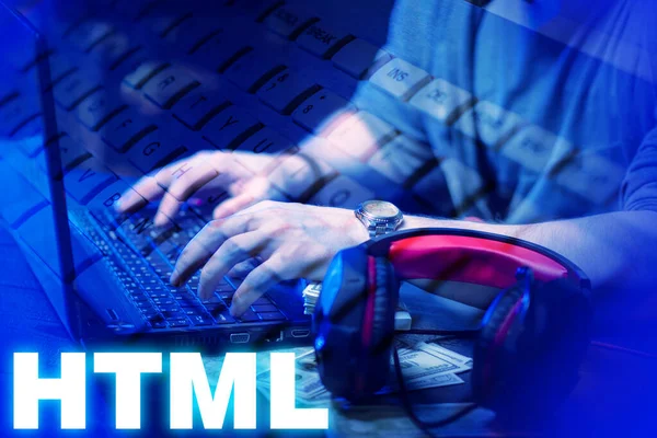 HTML development. Man writes the code. Hands of a man on a laptop keyboard. Concept - HTML programmer vacancy. HTML inscription next to developer. Work for programmers. Employment web developer.