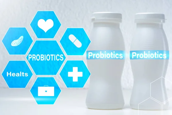 Probiotic. Probiotics logo on a light background and on kefir bottles. Useful bacteria in food products. Probiotics and prebiotics in fermented milk products.