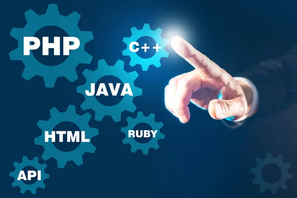 The concept of programming languages on a dark background. The names of programming languages in the gears. The person is drawn to the name of the desired computer language. Development of pc programs