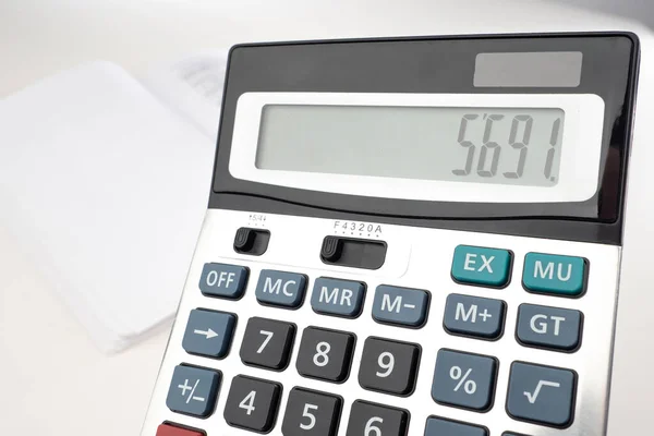 Calculator close-up. Counting money with a calculator. Calculator on the background of empty documents. Analysis of the budget of the company. Counting personal finances. Calculation of Tax Payments