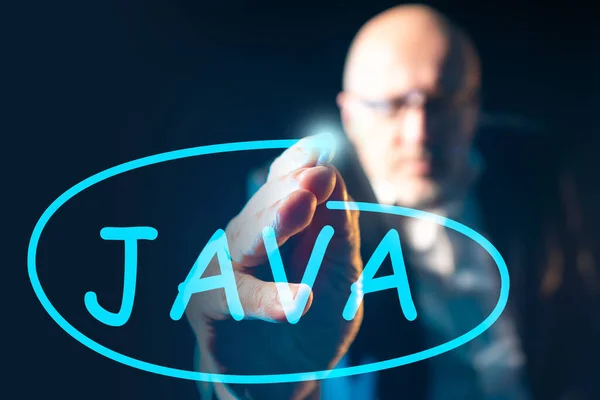 Java programming language. A man writes the word Java on a glass Board. Programming in Java. Computer language. Application developer.