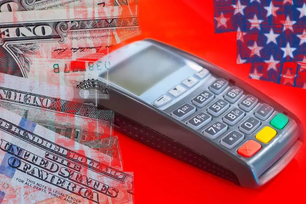 The methods of payment. Cash and non-cash payments. Payment terminal next to paper bills. Payment terminal and dollar bills. Concept of financial payments on a red background.
