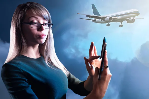 Buying air tickets. Girl buys a ticket through phone. Businesswoman buys a plane ticket. Air traffic. Purchasing airline tickets over Internet. Application for purchasing airline tickets. Air Travel