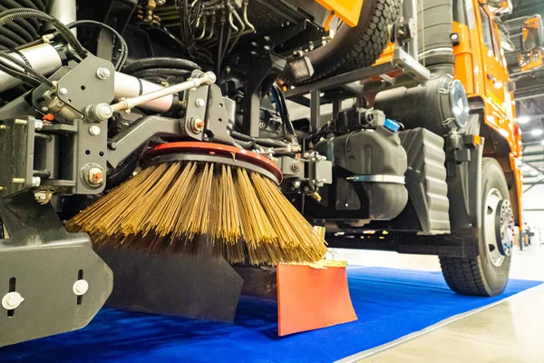 Demonstration of machines for street cleaning. Cleaning equipment in the exhibition hall. Fragment of the machine for sweeping sidewalks. Cleaning roads from snow and dirt. Communal service.