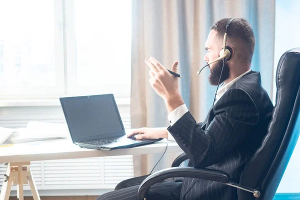 Customer support service. The man works as a consultant. Advising clients. Remote consultant. The man communicates with the client via video communication.
