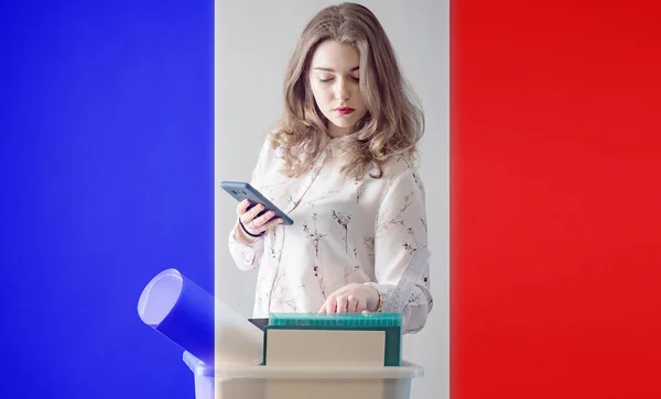 Dismissal. France woman lost job. Flag of France. Woman next to box. Concept - unemployed woman from France. Girl is looking for work on phone. Office supplies are in box. Depression due to dismissal