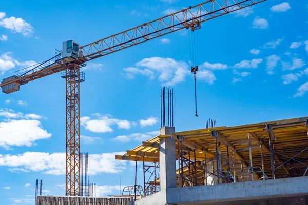 Tower construction crane. Fragment of a tower crane against the sky. Construction of buildings. Concept - construction business. Work as a crane operator. Career in the building business.