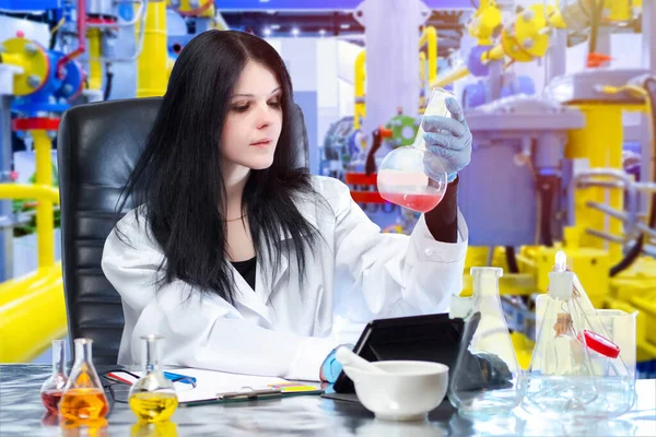 Laboratory assistant on the background of chemical production. Conducting laboratory tests at the enterprise. Quality control of raw materials for production. Control of products.