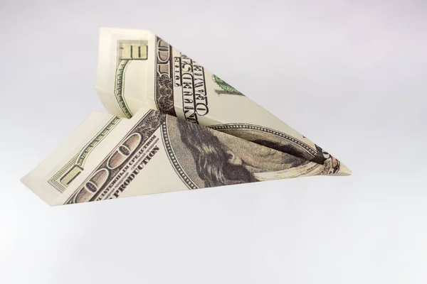 A plane made of a dollar bill. The metaphor is to waste money. A waste of money. Lack of financial literacy. Careless attitude to finances. — Stock Image Plane Made Dollar Bill Metaphor Waste Money Waste Money Lack Stock Photo