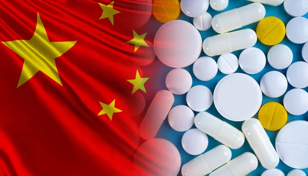 Pharmacological industry in China. Various tablets next to flag of China. Tablets are manufactured in People Republic of China. Chinese medicinal preparations. Concept - PRC healthcare