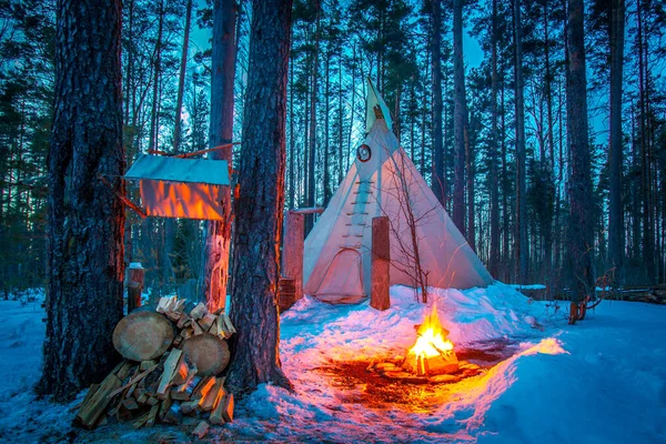 Tipi. Forest in winter. Indian Home. Bonfire in the forest. Ethnography. People of America. Living in the forest. Ecological tourism. Wigwam.