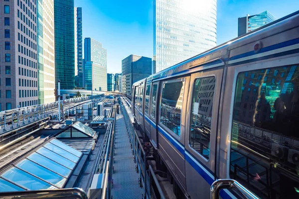 Japan. The transport system of Tokyo. The train goes to the business center of the Japanese capital. Transportation of passengers in Japan. Transportation routes and high-rise buildings in Tokyo.