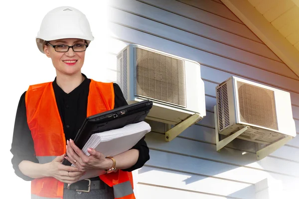 Girl-engineer on the background of air conditioners on the house. Maintenance of air conditioners. Installation of air conditioning and ventilation systems.