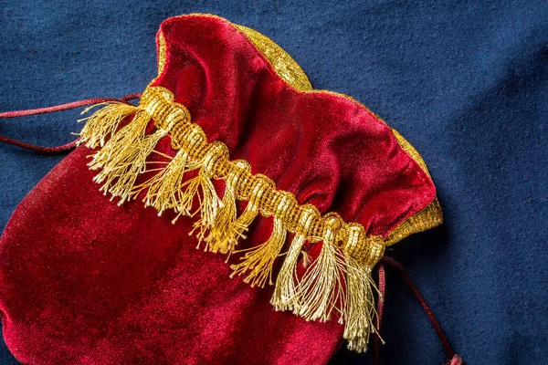 Big red pouch on a blue background — Stock Photo, Image