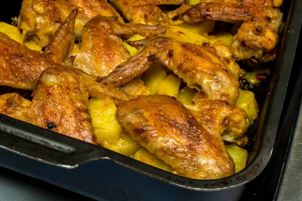 Sayap ayam panggang dengan kentang dalam oven — Stok Foto