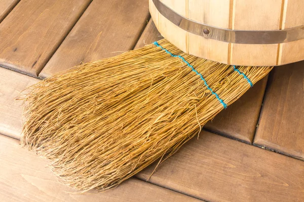 Wooden bucket with yellow broom in the sauna — Stock Photo, Image