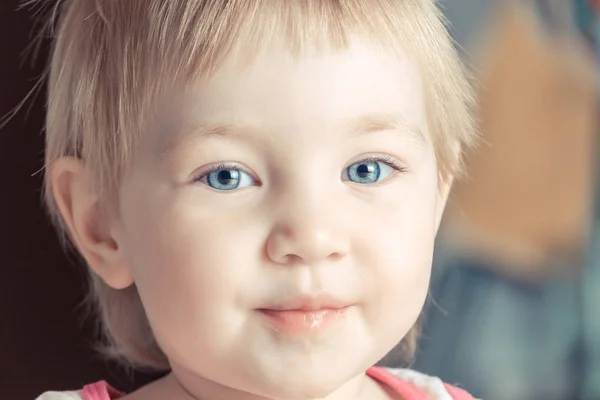 Criança feliz com grandes olhos azuis sorrisos . — Fotografia de Stock