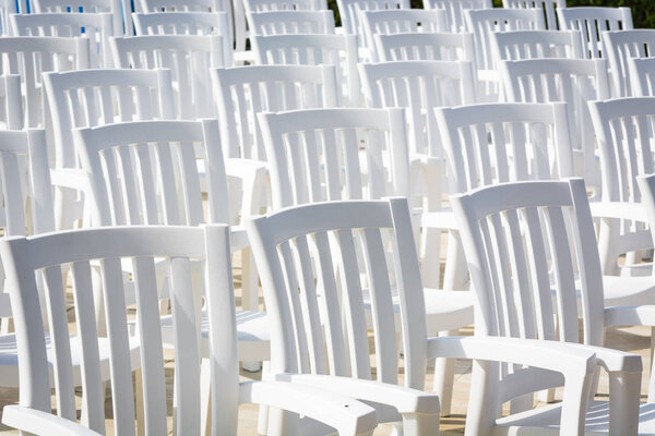 white chairs for watching performances on stage.