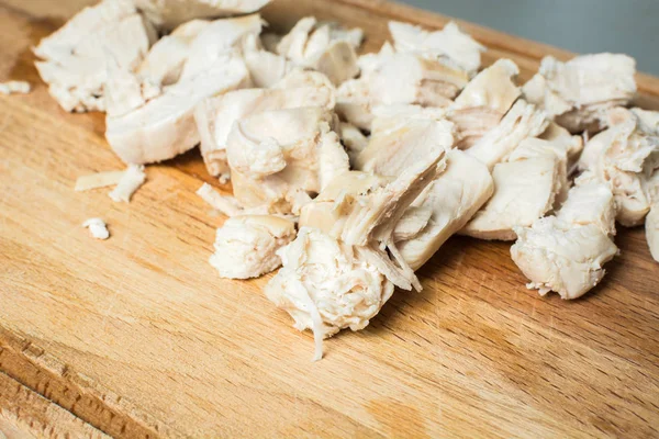 Sliced chicken breast for soup on wooden board. — Stock Photo, Image