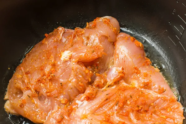 Raw chicken breast fillet marinated in hot spices cooked roasted in slow cooker. — Stock Photo, Image