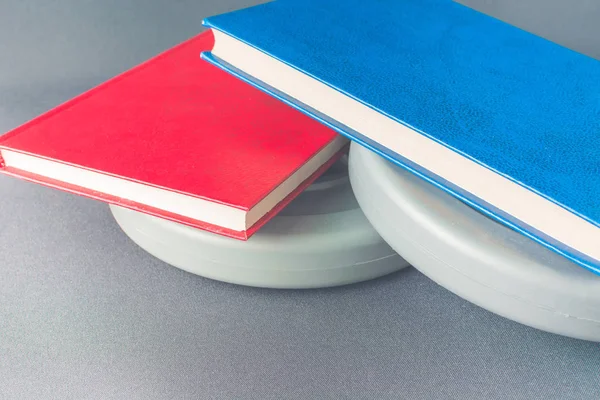 Multicolored books lie on gray pancakes from a sports bar