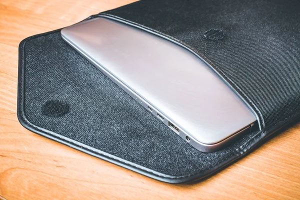 Ultra thin laptop in a bag on the desk — Stock Photo, Image