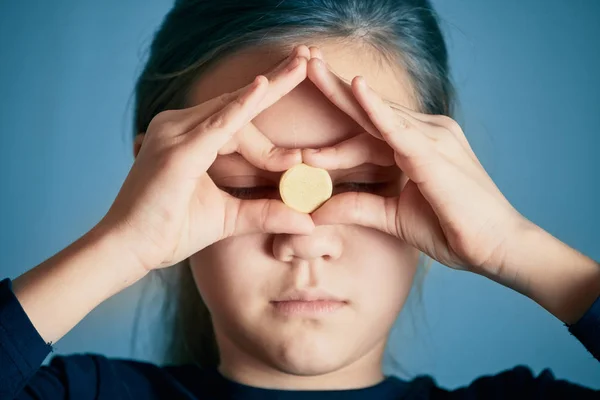 Schönes Mädchen mit großen Tabletten auf der Stirn und geschlossenen Augen. — Stockfoto